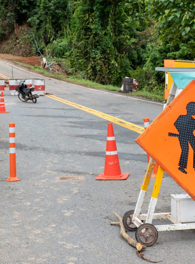 Traffic signs improve repairing on highway with landslide collapsed road